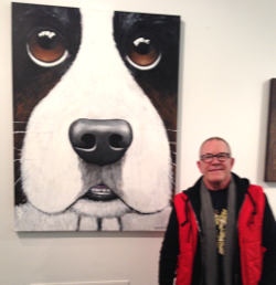 Kermit next to his painting which is on display at the Houston Art Car Museum